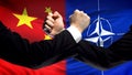 China vs NATO confrontation, countries disagreement, fists on flag background