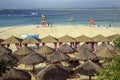 China Wuzhizhou Island - December 2 2018: Wuzhizhou Island. Beach chairs and umbrellas at sea beach. Beautiful beach with sun