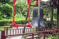 China, Wuzhizhou Island - December 2, 2018: Wuzhizhou Island. Chinese bell and stick for striking, from tree trunks; editorial