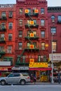 Chinatown neighborhood in Lower Manhattan NYC daylight view showing shops in the street with Chinese letters ,symbols and people