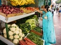 Indian woman buys fruits and vegetables at the market