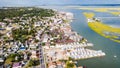 Chincoteague Island, marinas, houses and motels with parking lots. bridge and road along the bay. Drone view