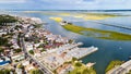 Chincoteague Island, marinas, houses and motels with parking lots. bridge and road along the bay. Drone view