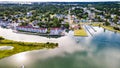 Chincoteague Island, marinas, houses and motels with parking lots. Road along the bay. Drone view