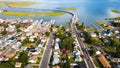 Chincoteague Island, residential areas and marinas, houses and motels with car parks. bridge and road along the bay. Drone view Royalty Free Stock Photo