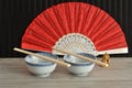 Chines bowls, chopsticks, a hand fan and a Buddha Royalty Free Stock Photo