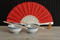 Chines bowls, chopsticks, a hand fan and a Buddha Royalty Free Stock Photo