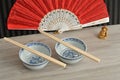 Chines bowls, chopsticks, a hand fan and a Buddha Royalty Free Stock Photo