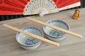 Chines bowls, chopsticks, a hand fan and a Buddha Royalty Free Stock Photo