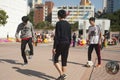 Chines teenagers playing football at public playground