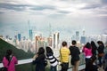 Chinese anonymous people looking at Hong Kong skyline from Victoria`s peak