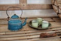 Antique teapot and cups on bamboo table Royalty Free Stock Photo