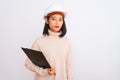 Chinese architect woman wearing helmet holding clipboard over isolated white background with a confident expression on smart face Royalty Free Stock Photo
