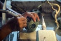 Chinese artisan carver hand carving a round jade puzzle ball also called a Generation Ball representing family generations