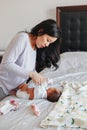 Chinese Asian busy mother changing diaper for newborn infant baby Royalty Free Stock Photo