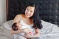 Chinese Asian mother holding cute adorable newborn infant baby son daughter. Royalty Free Stock Photo