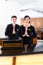 Chinese Asian reception team at hotel front desk Royalty Free Stock Photo