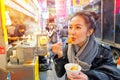 Chinese Asian young female model eating Chinese Steamed Dumpling on Street in Hong Kong Royalty Free Stock Photo