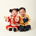 Chinese baby boy and girl in traditional Chinese New Year outfit