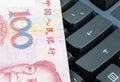 Chinese banknote on the computer keyboard