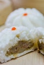 Chinese barbecued pork bun tear into two half.