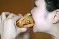 Chinese beauty girl eat hamburger, blank white background Royalty Free Stock Photo