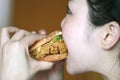 Chinese beauty girl eat hamburger Royalty Free Stock Photo