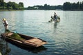 Chinese boaters clean the lake from algae in the park