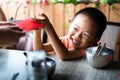 Chinese boy receiving red pocket on the table Royalty Free Stock Photo