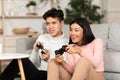 Chinese Boyfriend And Girlfriend Playing Video Games Sitting At Home Royalty Free Stock Photo