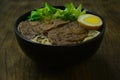 Chinese Braised Beef Noodle with Beef shanks slice served Egg in Brown sauce