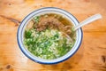 Chinese braised pork meat soup dish on wooden table