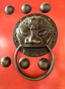 Chinese bronz lion knob on red gate doors Royalty Free Stock Photo