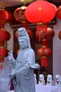 Chinese Buddhist statue and red lanterns. Royalty Free Stock Photo