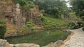 Chinese Buddha stone statue near pond