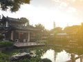 Chinese building around pond with reflection in water and beautiful garden during sunset, architecture concept Royalty Free Stock Photo