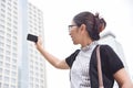 Chinese Business Woman taking photo with her smart phone. Royalty Free Stock Photo