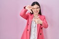 Chinese business young woman wearing glasses smiling making frame with hands and fingers with happy face Royalty Free Stock Photo