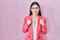 Chinese business young woman wearing glasses success sign doing positive gesture with hand, thumbs up smiling and happy Royalty Free Stock Photo