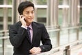 Chinese Businessman Outside Office On Mobile Phone Royalty Free Stock Photo