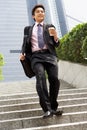 Chinese Businessman Rushing Down Steps