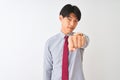 Chinese businessman wearing elegant tie standing over isolated white background Punching fist to fight, aggressive and angry Royalty Free Stock Photo