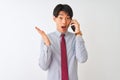 Chinese businessman wearing tie talking on the smartphone over isolated white background very happy and excited, winner expression Royalty Free Stock Photo