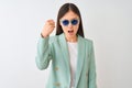 Chinese businesswoman wearing jacket and sunglasses over isolated white background annoyed and frustrated shouting with anger, Royalty Free Stock Photo