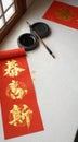 Chinese calligraphy materials on a table with red scrolls Royalty Free Stock Photo