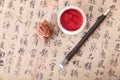 Chinese calligraphy and a seal and ink pad and a carving knife Royalty Free Stock Photo