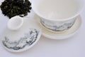 Chinese carving tea cup and raw tea leaf Royalty Free Stock Photo