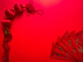 Chinese cash envelope and knots on red background for Chinese New Year