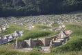 Chinese cemetery on the mound in the meadow next to the mountains.