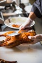 Chinese chef cooking peking roasted duck at the kitchen of restaurant Royalty Free Stock Photo